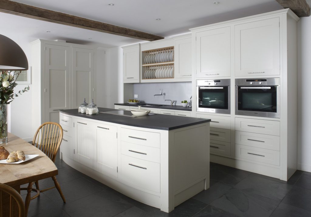 Chamber Furniture traditional Farmhouse Kitchen with stained oak cabinet seating area cream quartz