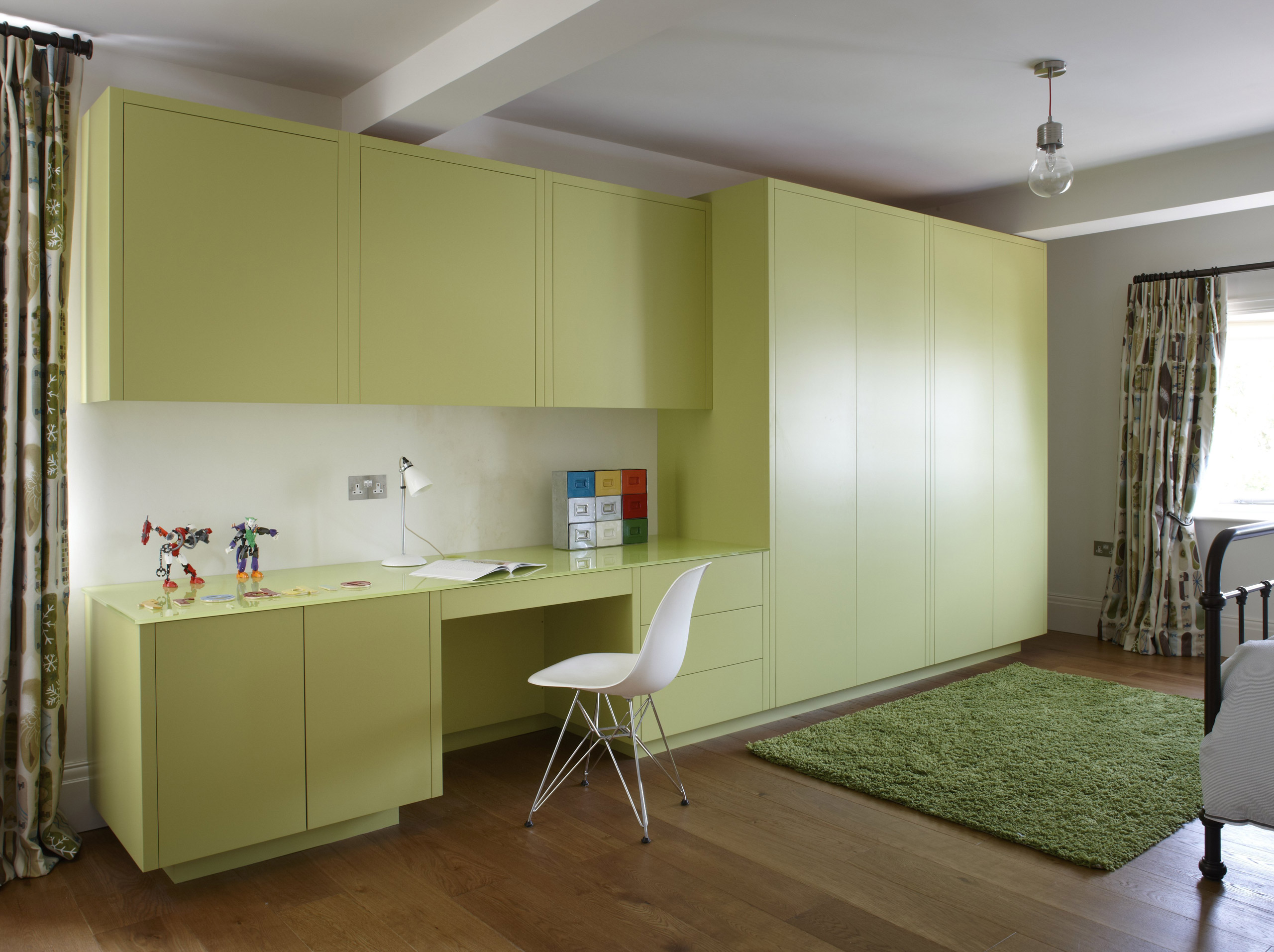 Contemporary lime-green cabinetry desk in childs room