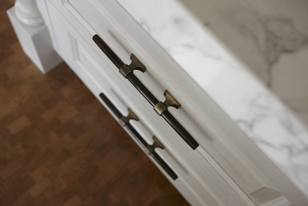 Ochre bone handles on the Modern Kitchen pan drawers in this Sevenoaks project by Chamber Furniture