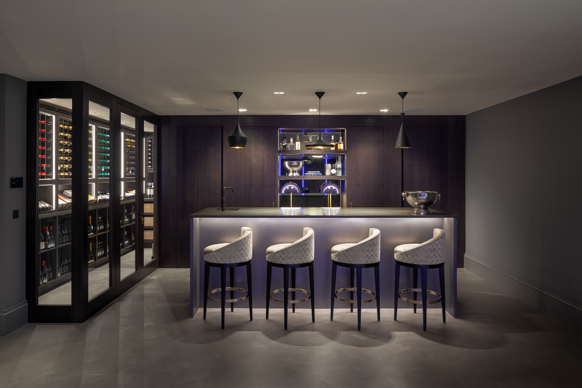 Sophisticated home bar area is finished in stained oak and pewter liquid metal