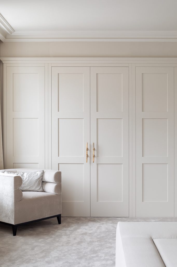 Disguised wardrobe doors in this luxurious bespoke bedroom design
